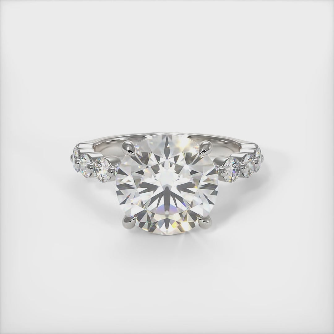 This gorgeous Round Moissanite and Lab-Created Diamonds Engagement Ring is sure to thrill her! This lovely sparkling ring in gold or platinum features a Colorless Round Moissanite set into the elegant 4 prong tulip pave head. This bridal ring is available in 2ct, 3ct, 4ct/ AGI Design