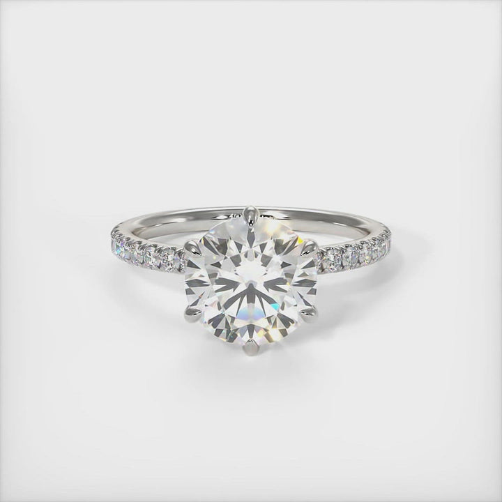 Evie round moissanite engagement ring/AGI Design/A beautiful Engagement ring in gold or platinum that includes a round Colorless  Moissanite set into the 6 prongs setting and high-quality lab-created diamonds on the band. This 1ct, 2ct, 3ct solitaire ring is designed to allow the wedding band to sit close and flush with the engagement ring because the center stone sits directly above the band. 