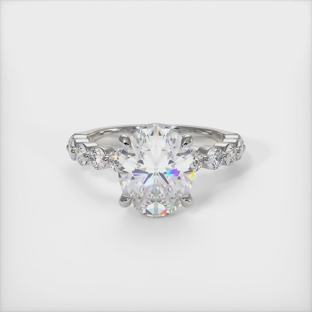 This gorgeous Oval   Moissanite and Lab-Created Diamonds Engagement Ring is sure to thrill her! This lovely sparkling ring in gold or platinum features a Colorless Round Moissanite set into the elegant 4 prong tulip pave head. This bridal ring is available in 2ct, 3ct, 4ct/ AGI Design