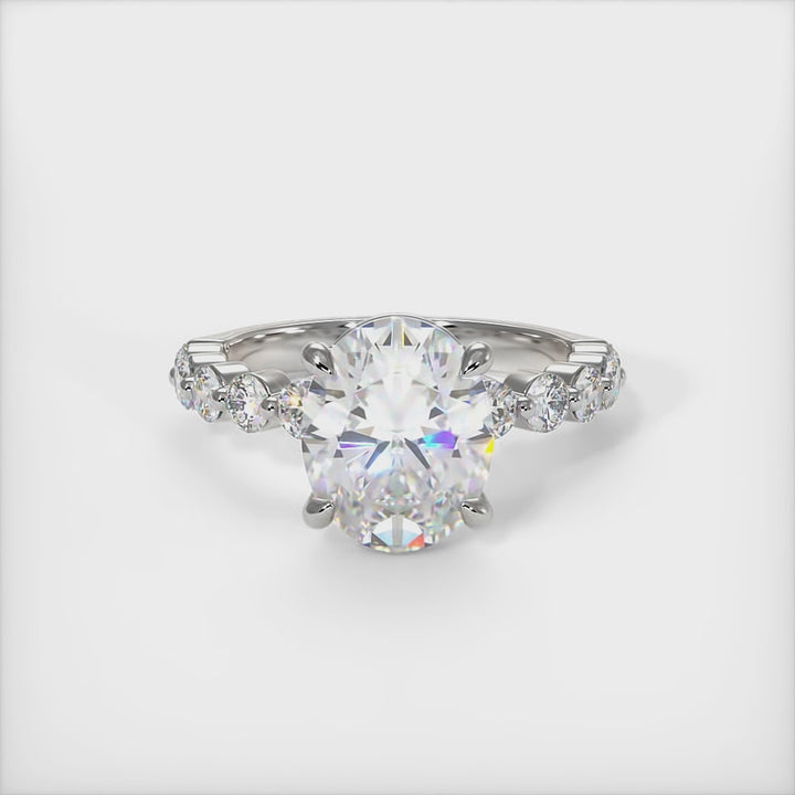 This gorgeous Oval   Moissanite and Lab-Created Diamonds Engagement Ring is sure to thrill her! This lovely sparkling ring in gold or platinum features a Colorless Round Moissanite set into the elegant 4 prong tulip pave head. This bridal ring is available in 2ct, 3ct, 4ct/ AGI Design