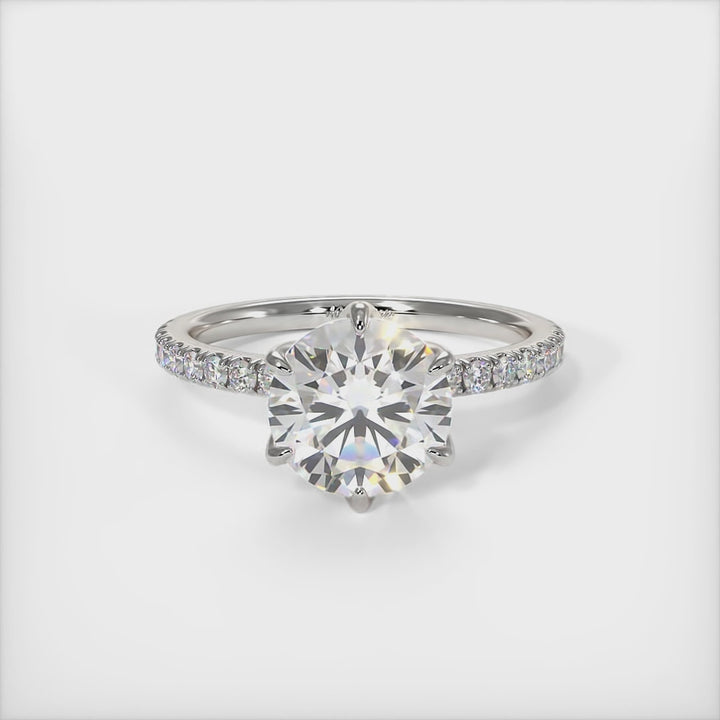 This gorgeous round Moissanite and Lab-Created Diamonds Engagement Ring is sure to thrill her! This lovely sparkling bridal ring in gold or platinum features a 1ct, 2ct round Moissanite set into the elegant 6 prong tulip head. A shimmering diamond-lined shank completes the lovely look. AGI Design