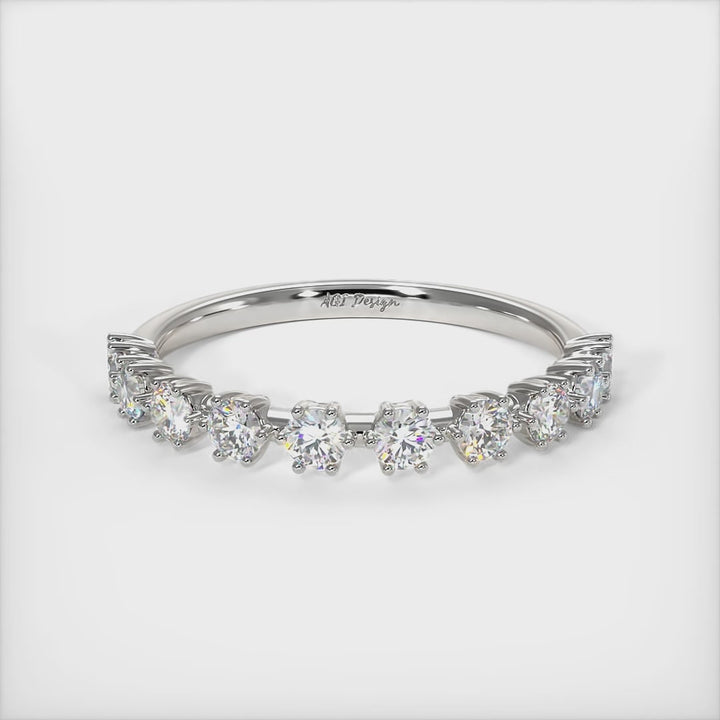 Delicately crafted in solid gold or platinum, this band is 2.5mm wide set with round brilliant cut Lab-created diamonds. This bridal ring can be made with moissanite./AGI Design