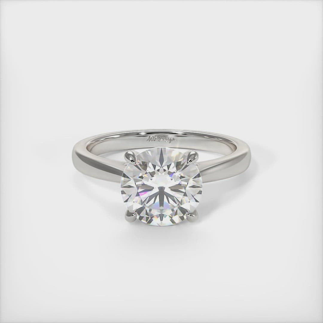 Aurora round moissanite engagement ring/AGI Design A beautiful engagement ring in gold or platinum that includes a  1ct,  2ct, 3ct round Colorless Moissanite set into the 4 prongs setting. This solitaire ring is designed to allow the wedding band to sit close and flush with the engagement ring because the center stone sits directly above the band.