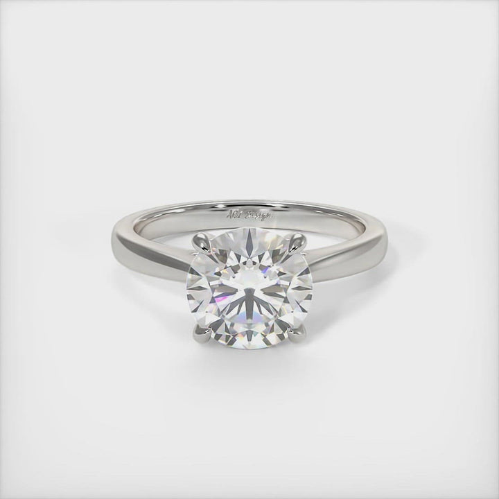 Aurora round moissanite engagement ring/AGI Design A beautiful engagement ring in gold or platinum that includes a  1ct,  2ct, 3ct round Colorless Moissanite set into the 4 prongs setting. This solitaire ring is designed to allow the wedding band to sit close and flush with the engagement ring because the center stone sits directly above the band.