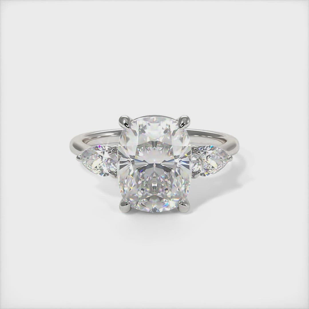 Leah cushio cut moissanite with pear shape lab created diamonds engagement ring/This elegant solid gold or platinum engagement ring features a cushion-cut moissanite and pear-shaped lab-created diamonds. This 1ct, 2ct three stone ring is designed to allow the wedding band to sit close and flush with the engagement ring. /AGI design
