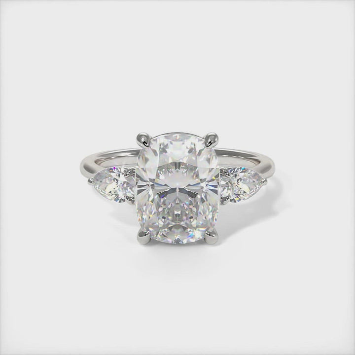 Leah cushio cut moissanite with pear shape lab created diamonds engagement ring/This elegant solid gold or platinum engagement ring features a cushion-cut moissanite and pear-shaped lab-created diamonds. This 1ct, 2ct three stone ring is designed to allow the wedding band to sit close and flush with the engagement ring. /AGI design