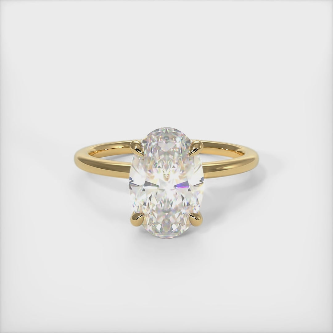 A beautiful engagement ring in gold or platinum that includes a colorless Oval Moissanite set into the 4 prongs hidden halo setting. The band and the halo are covered with lab-created diamonds. This 1ct, 2ct, 3ct, solitaire ring is designed to allow the wedding band to sit  flush with the engagement ring because the center stone sits directly above the band./AGI Design