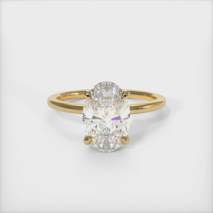 A beautiful engagement ring in gold or platinum that includes a colorless Oval Moissanite set into the 4 prongs hidden halo setting. The band and the halo are covered with lab-created diamonds. This 1ct, 2ct, 3ct, solitaire ring is designed to allow the wedding band to sit  flush with the engagement ring because the center stone sits directly above the band./AGI Design