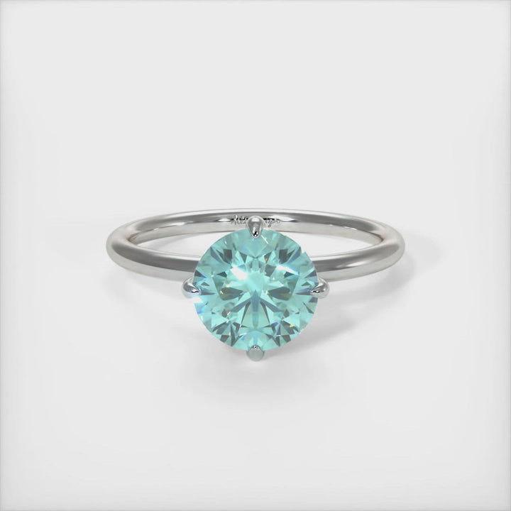 Lisa Round Aqua-Teal Moissanite Engagement Ring - AGI Design/A beautiful Engagement ring in gold or platinum that includes a round Aqua Teal Moissanite set into the 4 prongs compass setting. Each claw points to North, East, South, West in contrast to the traditional "box" style arrangement when the moissanite is set to square on. 1ct, 2ct, 3ct solitaire rings are available.