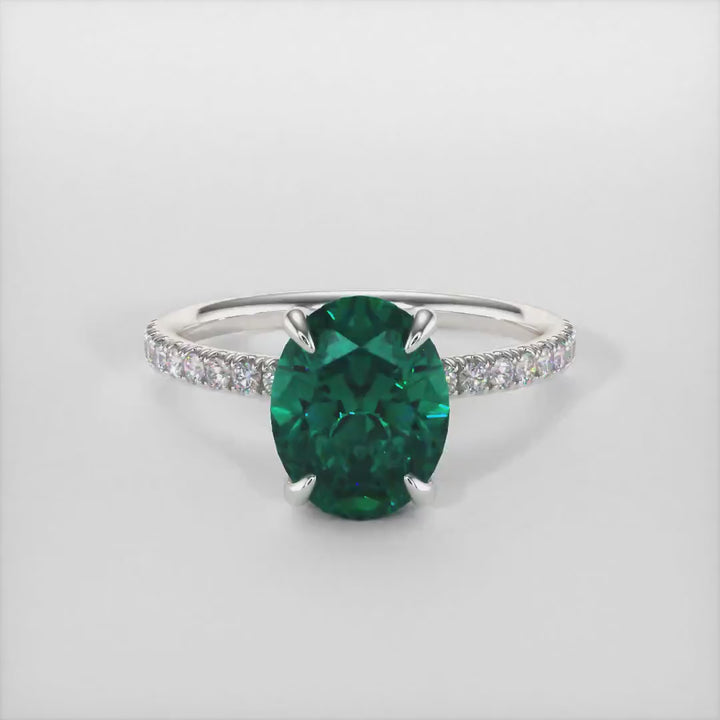 Abigail Oval Green Moissanite Engagement Ring/ AGI Design. A beautiful engagement ring in gold or platinum that includes a green Oval Moissanite set into the 4 prongs hidden halo setting. The band and the halo are covered with lab-created diamonds. This solitaire ring is designed to allow the wedding band to sit  flush with the engagement ring because the center stone sits directly above the band.