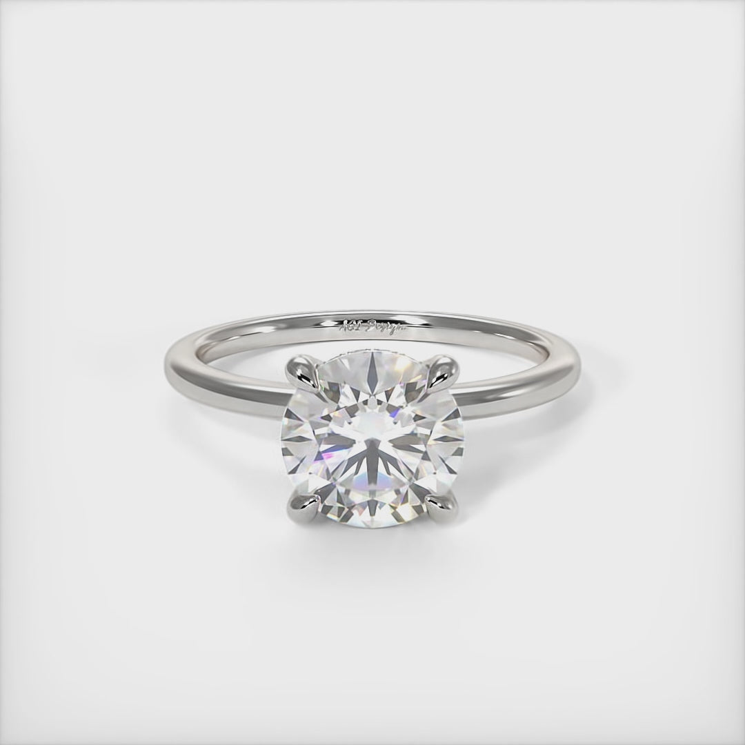A beautiful engagement ring in gold or platinum that includes a  1ct,  2ct, 3ct round Colorless Moissanite set into the 4 prongs setting. This solitaire ring is designed to allow the wedding band to sit close and flush with the engagement ring because the center stone sits directly above the band./ AGI Design
