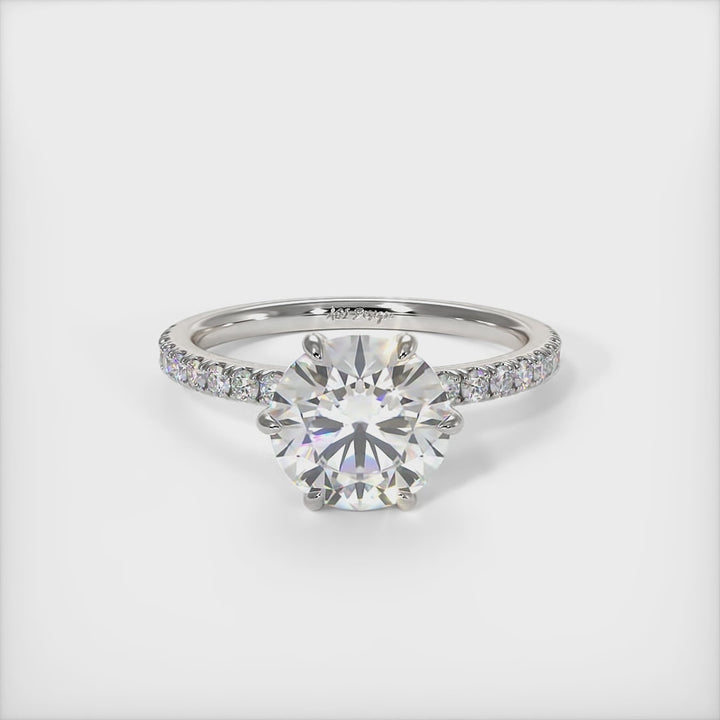 This gorgeous round Colorless Moissanite and Lab-Created Diamonds Engagement Ring is sure to thrill her! This lovely sparkling ring  in gold or platinum features a round Moissanite set into the elegant 4 prong tulip head.  This 1ct, 2ct 3ct  solitaire ring is designed to sit flush with a straight band./AGI Design