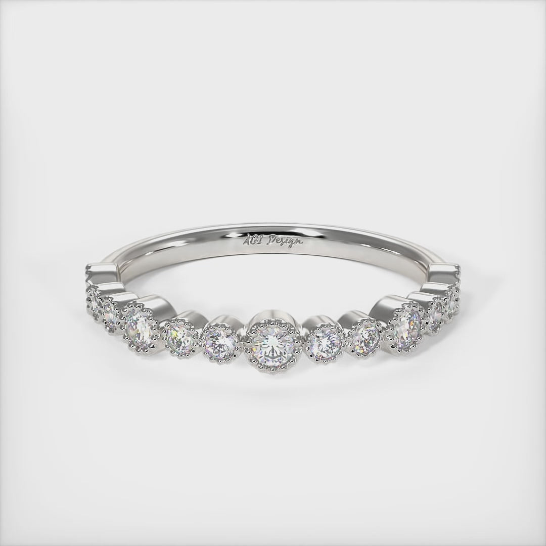Delicately crafted in solid gold or platinum, this band is 2.5mm wide set with round brilliant cut Lab-created diamonds. This bridal ring can be made with moissanite./AGI Design