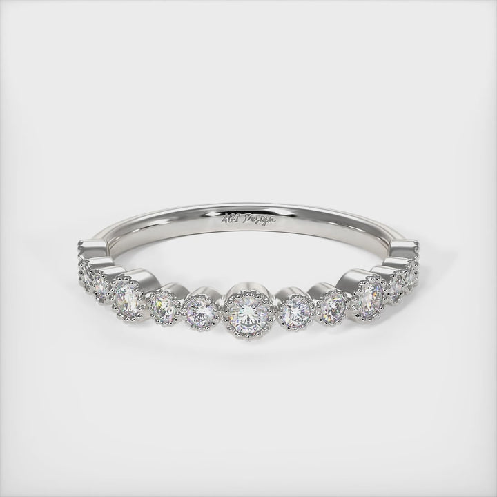 Delicately crafted in solid gold or platinum, this band is 2.5mm wide set with round brilliant cut Lab-created diamonds. This bridal ring can be made with moissanite./AGI Design