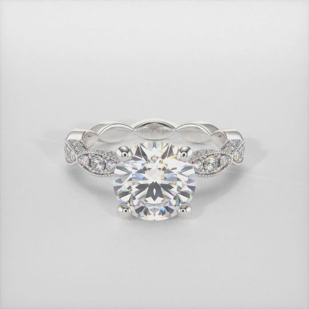 Dana round moissanite engagement ring/AGI Design This intricate round Forever One Moissanite engagement ring is available in gold or platinum and has a crisscross design that is filled with round pave-set lab-created diamonds in a round setting. You can choose from various moissanite sizes including 1ct, 2ct, 3ct for this bridal solitaire ring. 