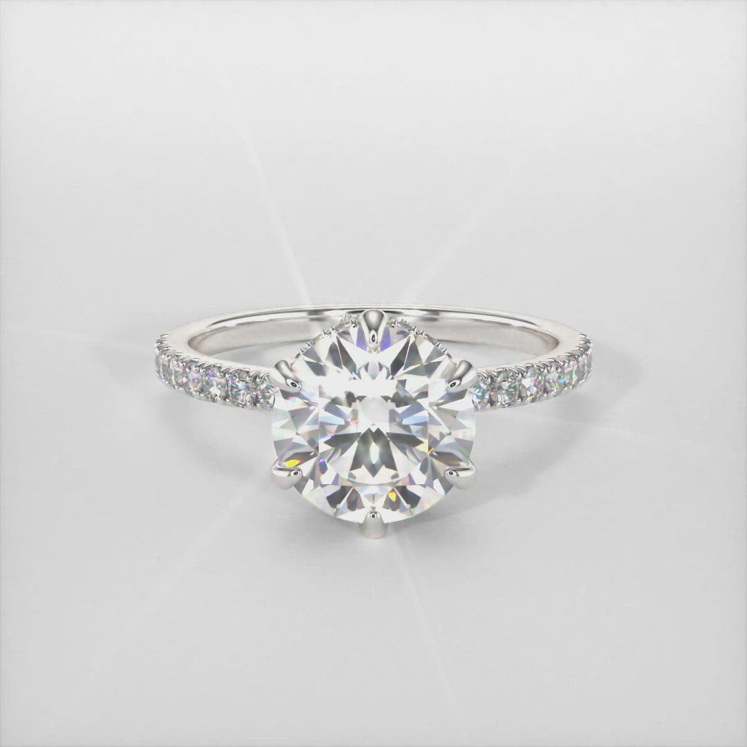 Jenny round moissanite engagement ring/AGI Design/This incredible engagement ring in gold or platinum features a round moissanite in a 6 prong setting surrounded by a hidden halo of round lab-created brilliant diamonds that make their way down the ring’s shank. This 1ct, 2ct solitaire  ring is designed to allow the wedding band to sit close and flush with the engagement ring.