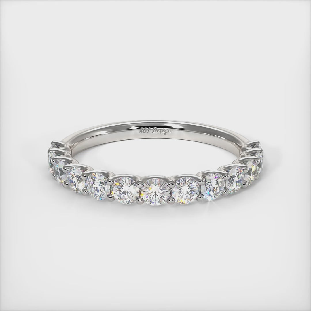 Delicately crafted in solid gold or platinum, this band is 2.5mm wide set with round brilliant cut Lab-created diamonds. This bridal ring can be made with moissanite./AGI Design