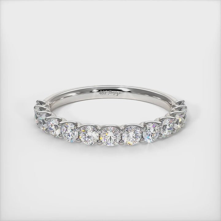 Delicately crafted in solid gold or platinum, this band is 2.5mm wide set with round brilliant cut Lab-created diamonds. This bridal ring can be made with moissanite./AGI Design