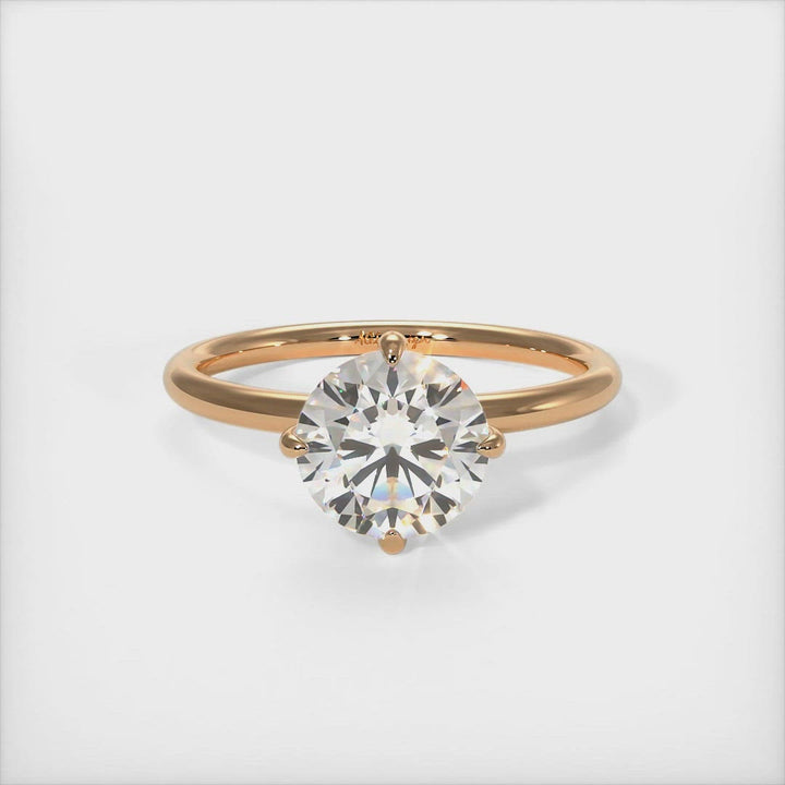 Lisa Round Moissanite Engagement Ring - AGI Design/A beautiful Engagement ring in gold or platinum that includes a round colorless Moissanite set into the 4 prongs compass setting. Each claw points to North, East, South, West in contrast to the traditional "box" style arrangement when the moissanite is set to square on. 1ct, 2ct, 3ct solitaire rings are available.