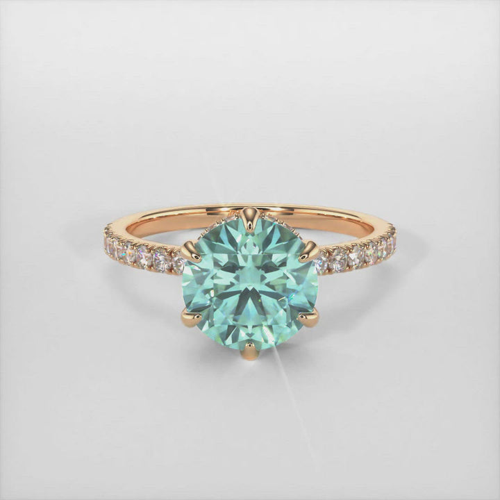Jenny round aqua teal moissanite engagement ring/AGI Design/This incredible engagement ring in gold or platinum features a round Aqua Teal Moissanite in a 6 prong setting surrounded by a hidden halo of round lab-created brilliant diamonds that make their way down the ring’s shank. This 1ct, 2ct ring is designed to allow the wedding band to sit close and flush with the engagement ring.