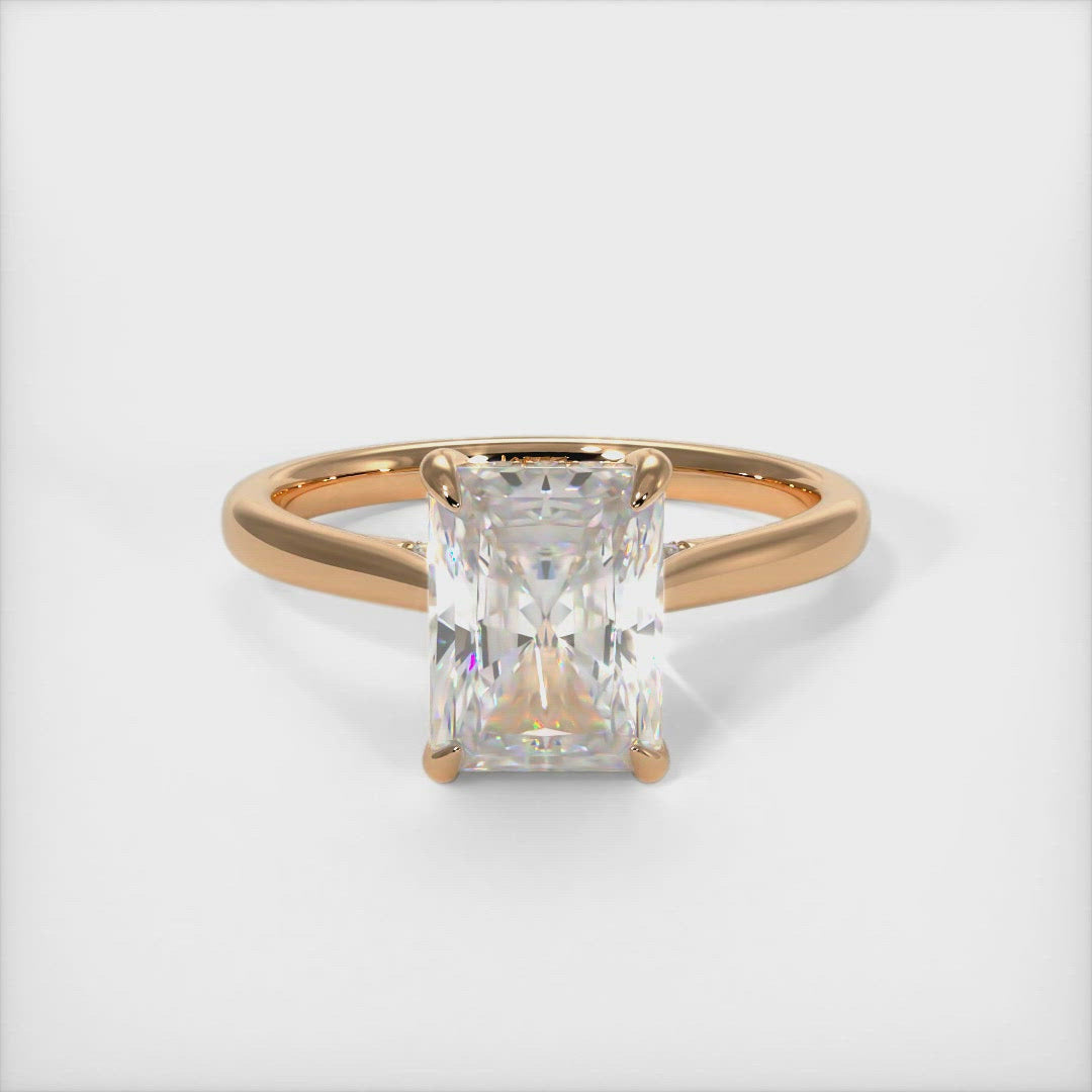 Bella radiant moissanite engagement ring/AGI Design  Crafted in solid gold or platinum, this intriguing design features a sparkling radiant-shaped Forever One moissanite center stone wrapped in a lab-created diamond-adorned hidden hallo frame. Sizes 1.2ct, 2.7ct, and 3.9ct are available for this unique solitaire ring 