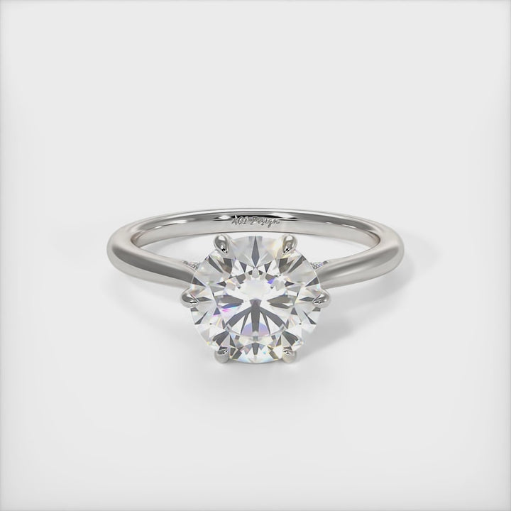 This gorgeous round Moissanite and Lab-Created Diamonds Engagement Ring is sure to thrill her! This lovely sparkling bridal ring in gold or platinum features a 1ct, 2ct round Moissanite set into the elegant 6 prong tulip head. A shimmering diamond-lined shank completes the lovely look./AGI Design