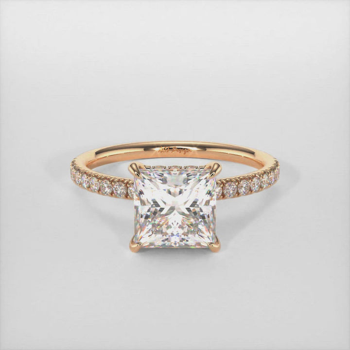 The gorgeous Hidden halo princess cut colorless moissanite engagement ring made of 14k, 18k gold, or platinum. The band and the halo are covered with high-quality Lab-created diamonds.  This ring is designed to allow the wedding band to sit close and flush with the engagement ring because the center stone sits directly above the band. AGI Design