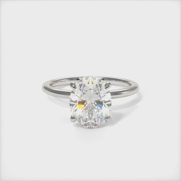 Grace oval moissanite engagement ring/AGI Design/ The delicate  engagement ring in gold or platinum features oval Colorless Moissanite as a center stone. The collar is covered with high-quality Lab-created diamonds. This 1ct, 2ct, 3ct solitaire ring is designed to allow the wedding band to sit close and flush with the engagement ring because the center stone sits directly above the band.